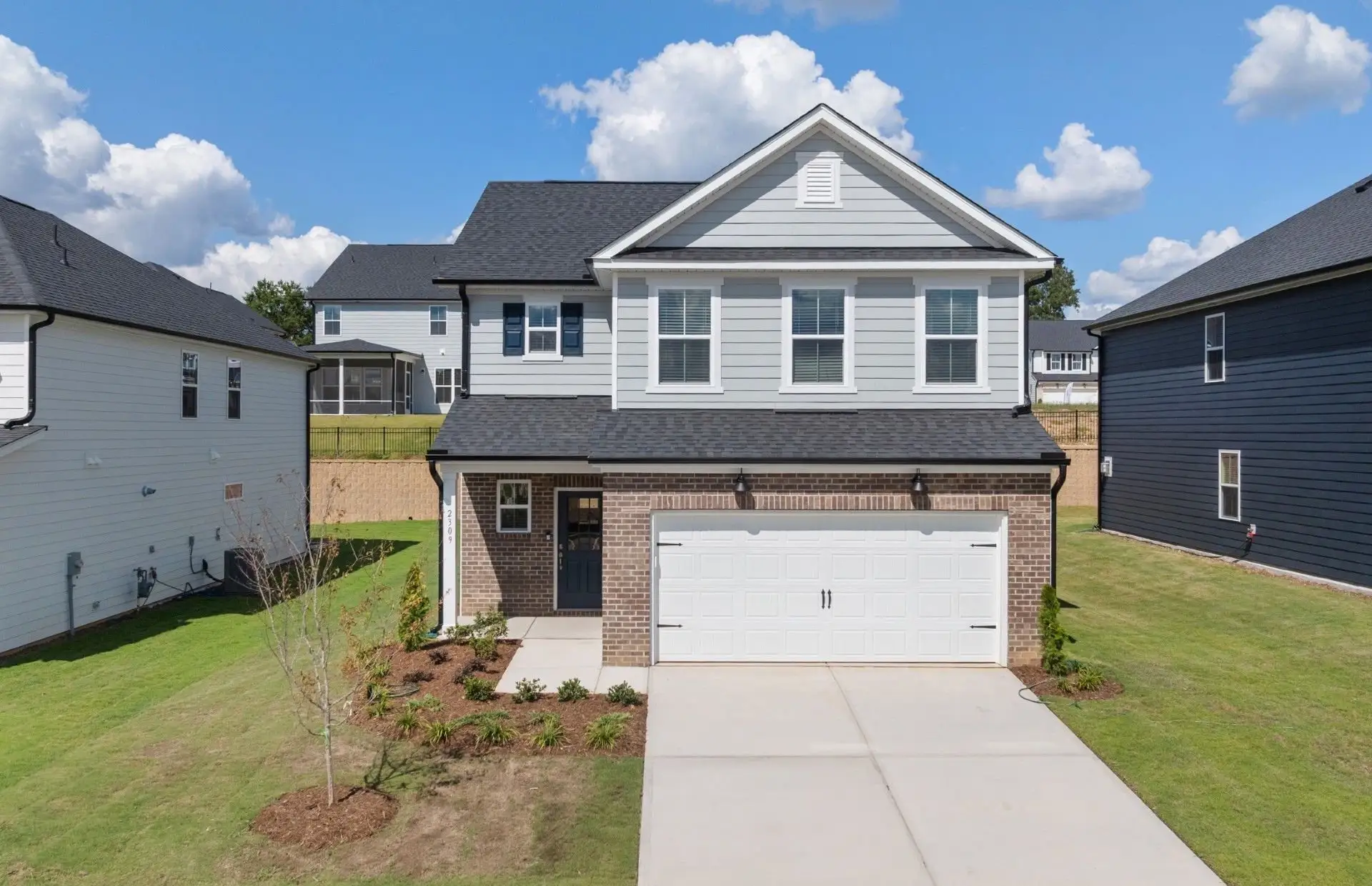 Front exterior of a new home in Providence Oaks, Fuquay Varina, NC, highlighting curb appeal (Image 1). Front exterior of a new home in Providence Oaks, Fuquay Varina, NC, highlighting curb appeal (Image 1).