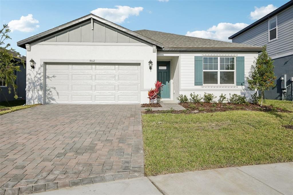 Front exterior of a new home in Coasterra - Reserve Series, Palmetto, FL, highlighting curb appeal (Image 1). Front exterior of a new home in Coasterra - Reserve Series, Palmetto, FL, highlighting curb appeal (Image 1).