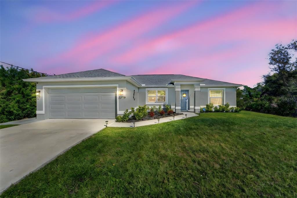 Front exterior of a new home in , North Port, FL, highlighting curb appeal (Image 1). Front exterior of a new home in , North Port, FL, highlighting curb appeal (Image 1).