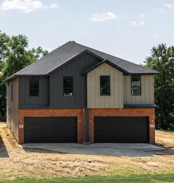 Modern duplex exterior featuring brick and vertical siding Modern duplex exterior featuring brick and vertical siding