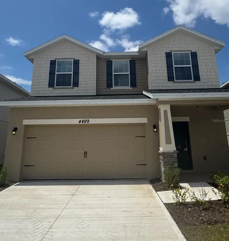 Front exterior of a new home in Harmony Central, St. Cloud, FL, highlighting curb appeal (Image 1).