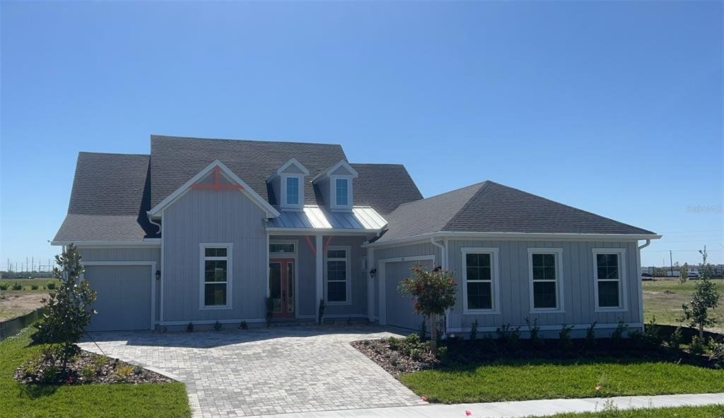 Front exterior of a new home in Waterset, Apollo Beach, FL, highlighting curb appeal (Image 1). Front exterior of a new home in Waterset, Apollo Beach, FL, highlighting curb appeal (Image 1).