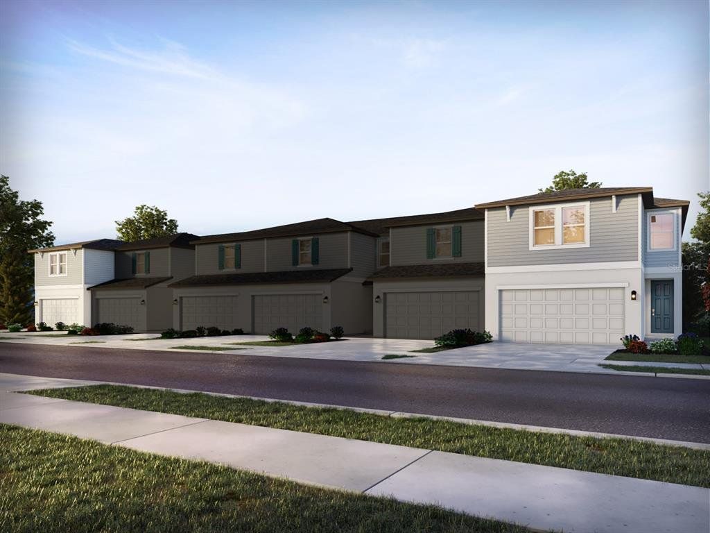 Front exterior of a new home in The Meadow at Crossprairie Townes, St. Cloud, FL, highlighting curb appeal (Image 1).