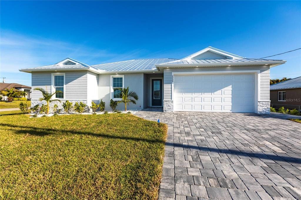 Front exterior of a new home in , Cape Coral, FL, highlighting curb appeal (Image 1). Front exterior of a new home in , Cape Coral, FL, highlighting curb appeal (Image 1).