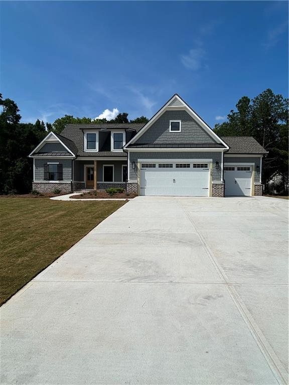 Front exterior of a new home in Riverwalk, Monroe, GA, highlighting curb appeal (Image 1). Front exterior of a new home in Riverwalk, Monroe, GA, highlighting curb appeal (Image 1).