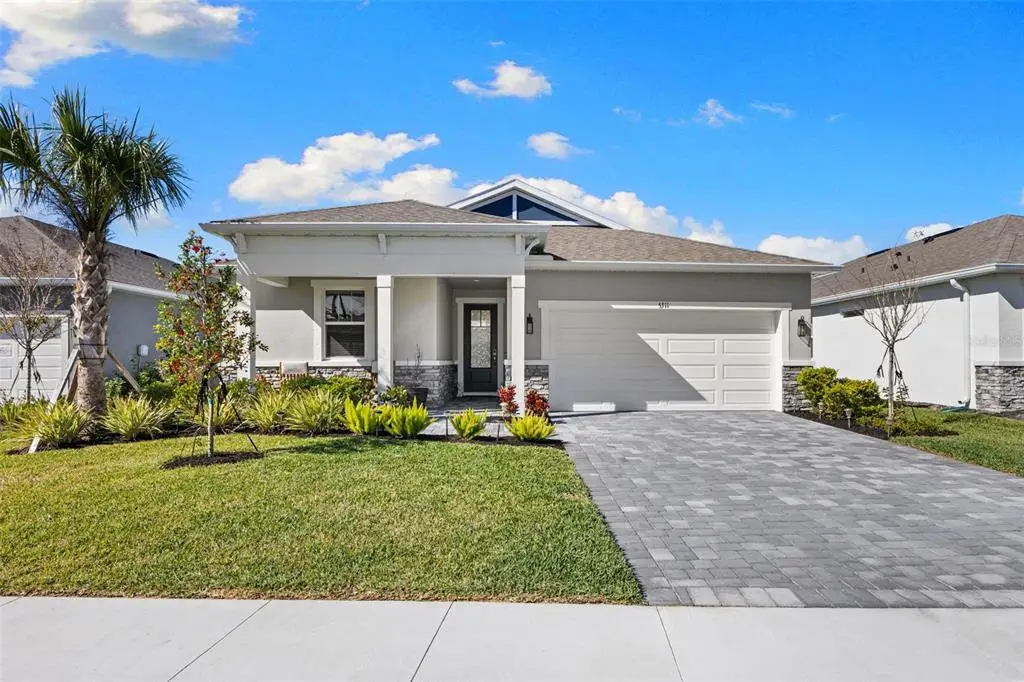 Front exterior of a new home in Windwater, Parrish, FL, highlighting curb appeal (Image 1). Front exterior of a new home in Windwater, Parrish, FL, highlighting curb appeal (Image 1).