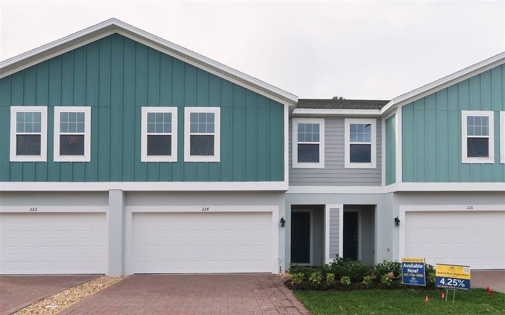 Front exterior of a new home in Blue Springs Reserve Townhomes, Groveland, FL, highlighting curb appeal (Image 1). Front exterior of a new home in Blue Springs Reserve Townhomes, Groveland, FL, highlighting curb appeal (Image 1).
