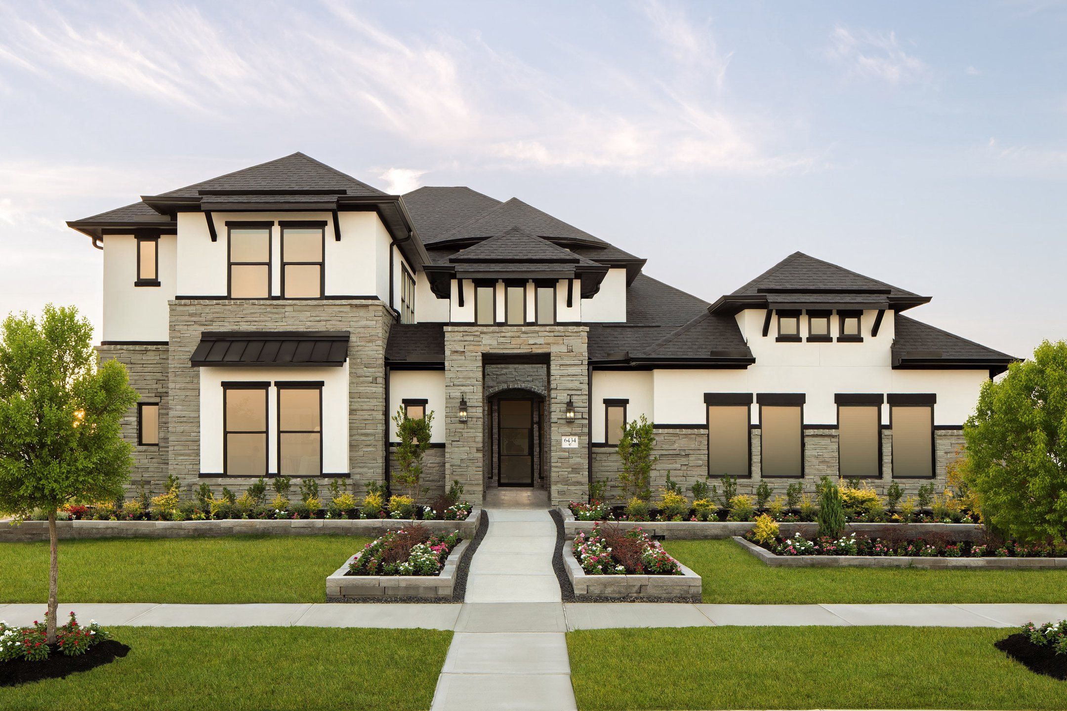 Front exterior of a new home in Valencia, Manvel, TX, highlighting curb appeal (Image 1). Front exterior of a new home in Valencia, Manvel, TX, highlighting curb appeal (Image 1).