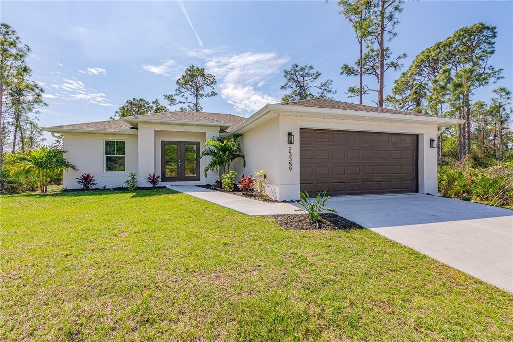 Front exterior of a new home in , North Port, FL, highlighting curb appeal (Image 1). Front exterior of a new home in , North Port, FL, highlighting curb appeal (Image 1).