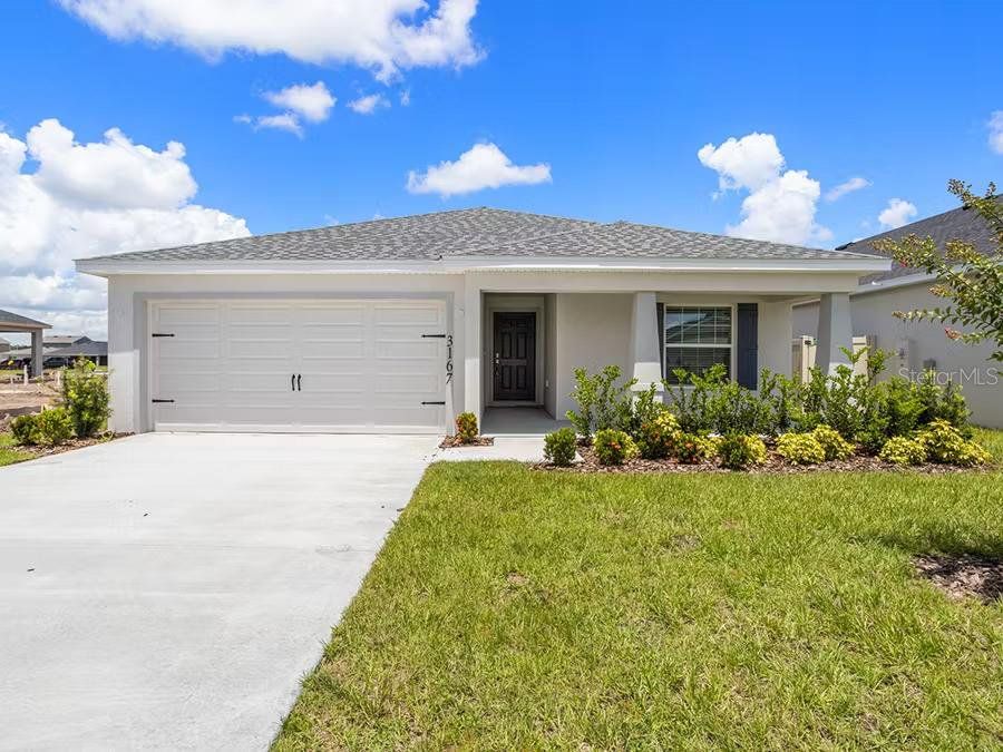 Front exterior of a new home in VillaMar, Winter Haven, FL, highlighting curb appeal (Image 1).