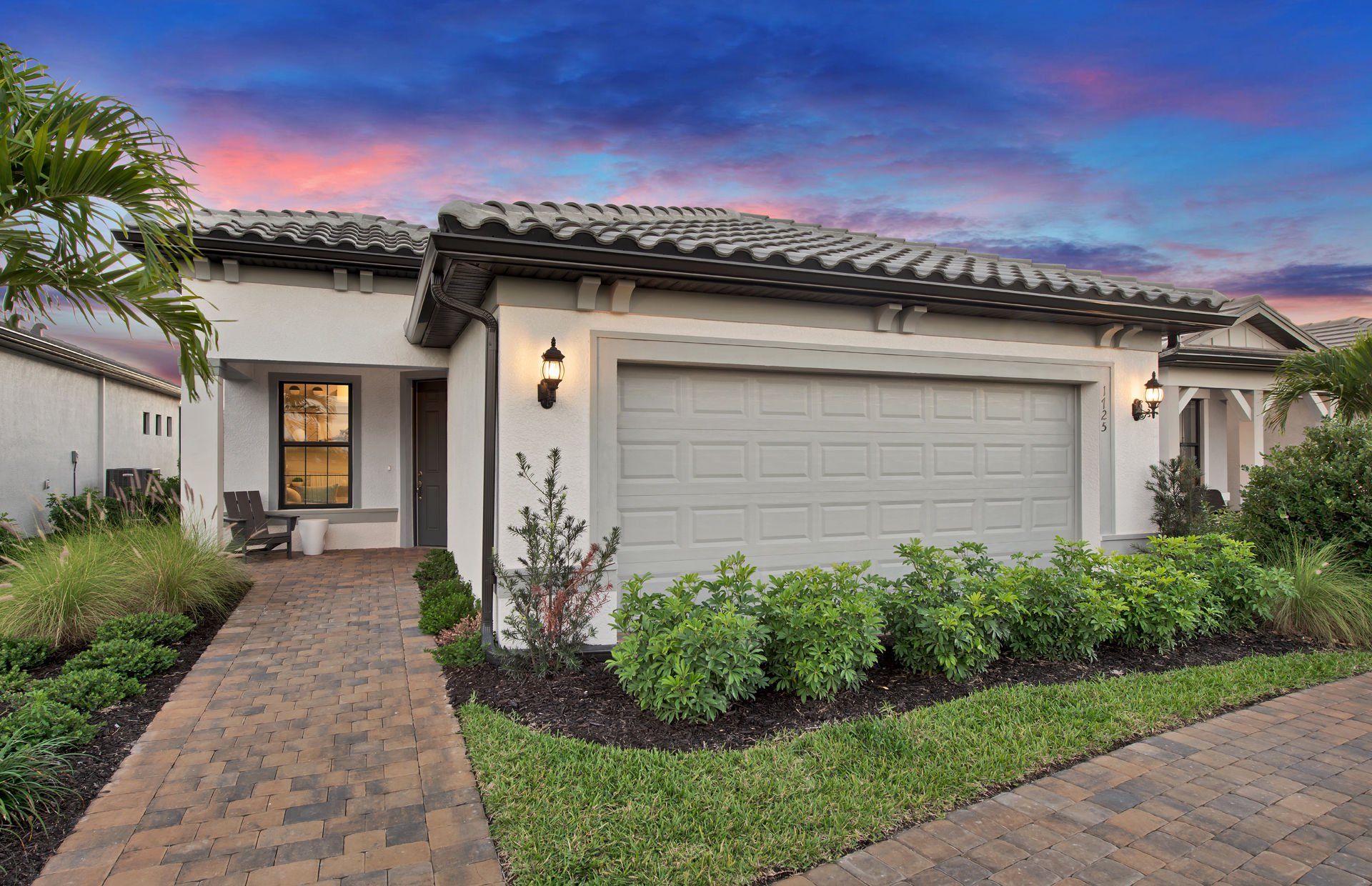 Front exterior of a new home in Terreno, Naples, FL, highlighting curb appeal (Image 1). Front exterior of a new home in Terreno, Naples, FL, highlighting curb appeal (Image 1).