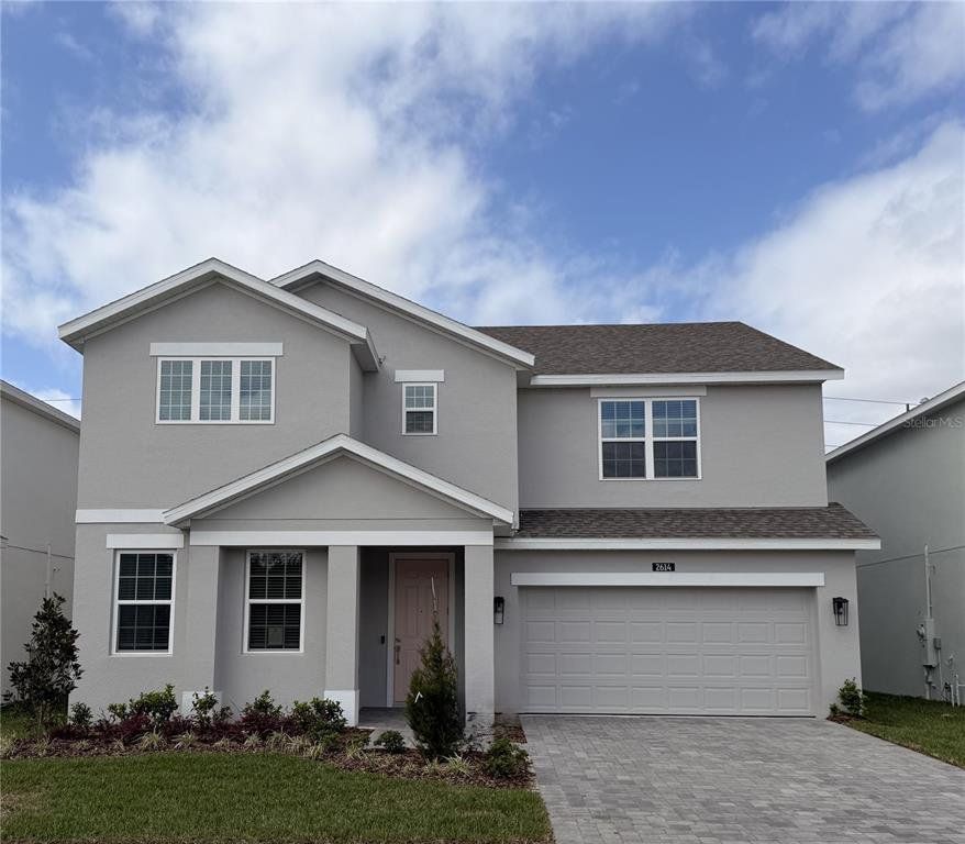 Front exterior of a new home in Harrell Oaks, Orlando, FL, highlighting curb appeal (Image 1). Front exterior of a new home in Harrell Oaks, Orlando, FL, highlighting curb appeal (Image 1).