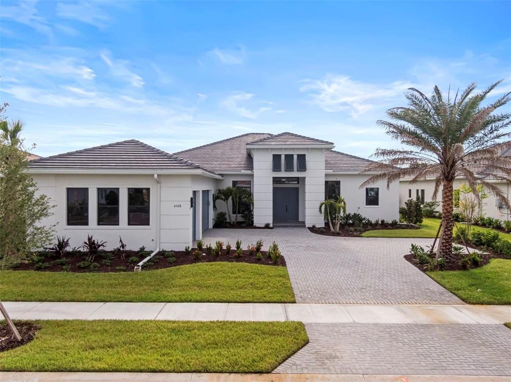 Front exterior of a new home in Artistry Sarasota, Sarasota, FL, highlighting curb appeal (Image 1).