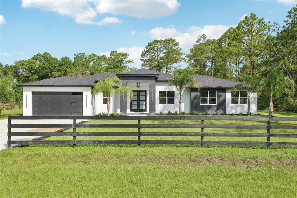 Front exterior of a new home in , Eustis, FL, highlighting curb appeal (Image 1). Front exterior of a new home in , Eustis, FL, highlighting curb appeal (Image 1).
