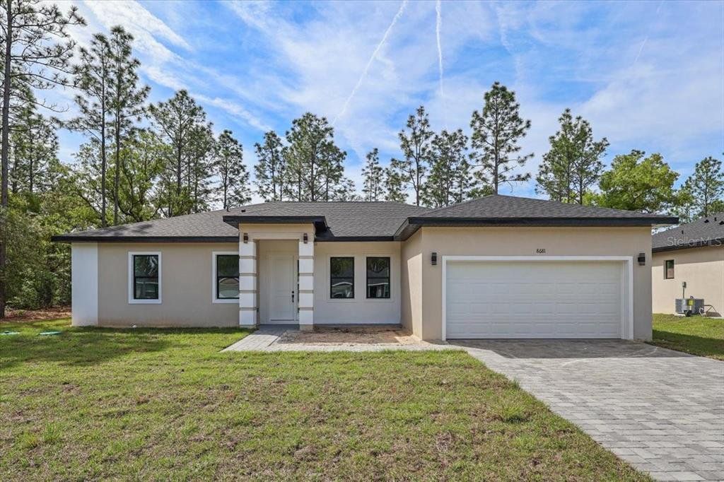 Front exterior of a new home in , Citrus Springs, FL, highlighting curb appeal (Image 1). Front exterior of a new home in , Citrus Springs, FL, highlighting curb appeal (Image 1).