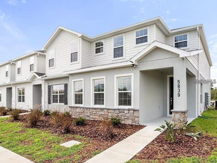 Exterior details and patio area of a home in The Crossings - Townhomes, St. Cloud (Image 1).