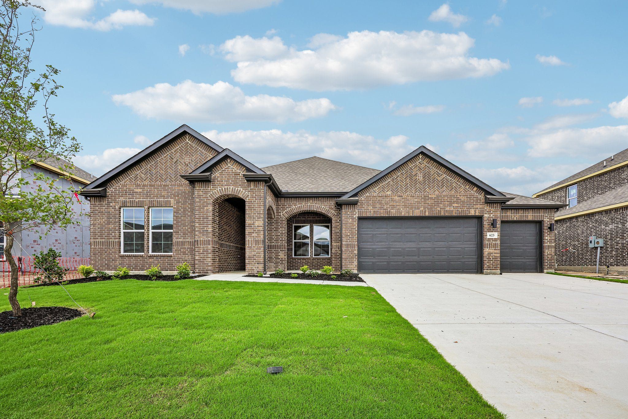 Front exterior of a new home in Overland Grove, Forney, TX, highlighting curb appeal (Image 1). Front exterior of a new home in Overland Grove, Forney, TX, highlighting curb appeal (Image 1).