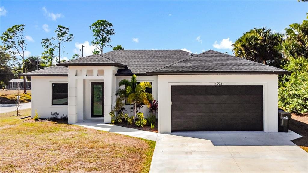 Front exterior of a new home in , North Port, FL, highlighting curb appeal (Image 1). Front exterior of a new home in , North Port, FL, highlighting curb appeal (Image 1).