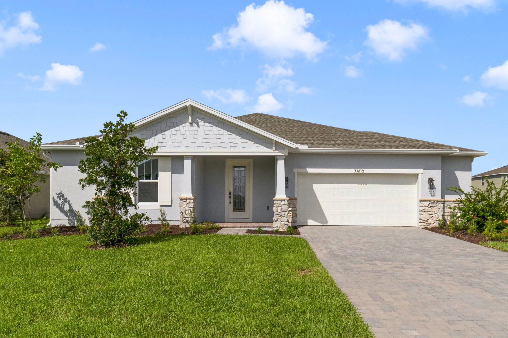 Front exterior of a new home in Acuera Estates, Apopka, FL, highlighting curb appeal (Image 1).