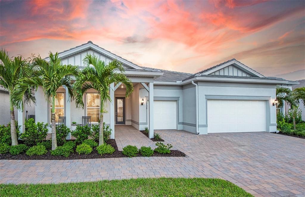 Front exterior of a new home in BeachWalk by Manasota Key, Englewood, FL, highlighting curb appeal (Image 1). Front exterior of a new home in BeachWalk by Manasota Key, Englewood, FL, highlighting curb appeal (Image 1).