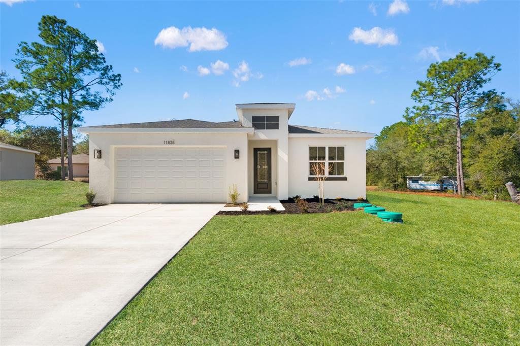 Front exterior of a new home in , Citrus Springs, FL, highlighting curb appeal (Image 1). Front exterior of a new home in , Citrus Springs, FL, highlighting curb appeal (Image 1).
