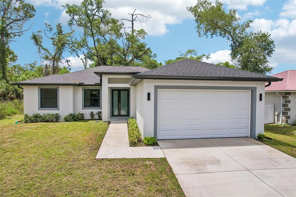 Front exterior of a new home in , Port Charlotte, FL, highlighting curb appeal (Image 1). Front exterior of a new home in , Port Charlotte, FL, highlighting curb appeal (Image 1).