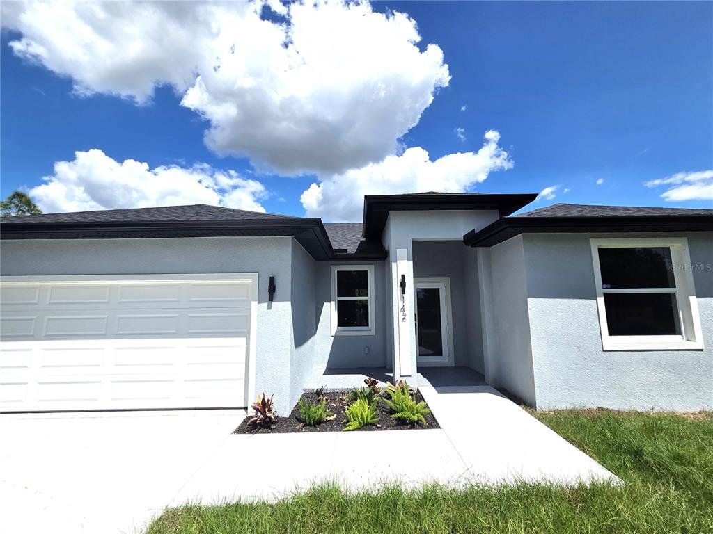 Front exterior of a new home in , Port Charlotte, FL, highlighting curb appeal (Image 1). Front exterior of a new home in , Port Charlotte, FL, highlighting curb appeal (Image 1).
