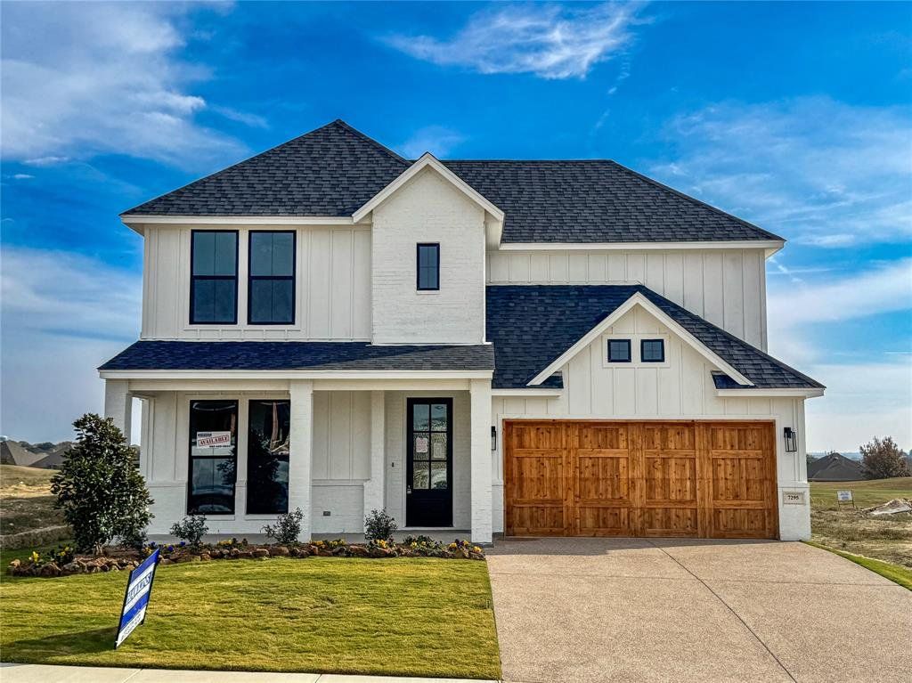 Modern inspired farmhouse featuring a shingled roof, a porch, board and batten siding, and a front lawn