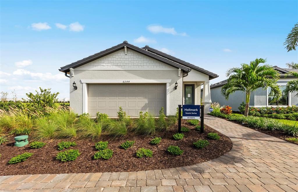 Front exterior of a new home in BeachWalk by Manasota Key, Englewood, FL, highlighting curb appeal (Image 1). Front exterior of a new home in BeachWalk by Manasota Key, Englewood, FL, highlighting curb appeal (Image 1).