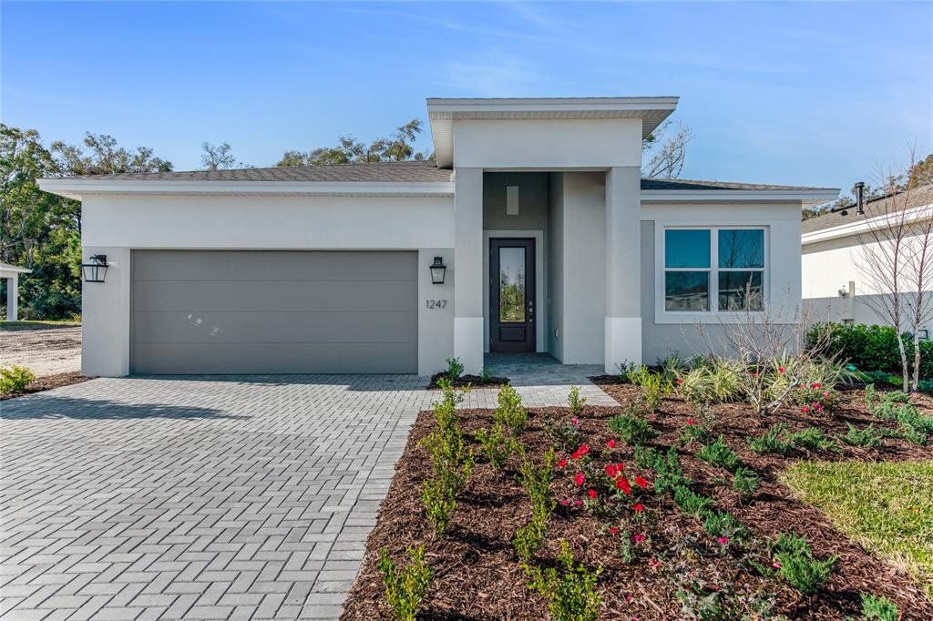 Front exterior of a new home in Cresswind DeLand, Deland, FL, highlighting curb appeal (Image 1).