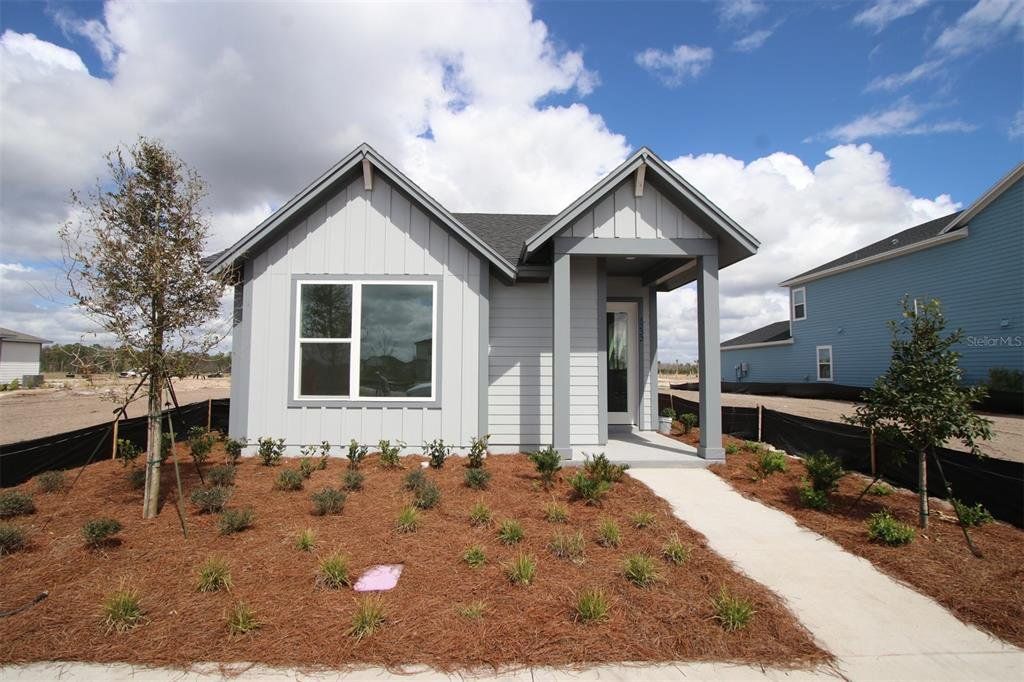 Front exterior of a new home in Weslyn Park in Sunbridge 34', St. Cloud, FL, highlighting curb appeal (Image 1). Front exterior of a new home in Weslyn Park in Sunbridge 34', St. Cloud, FL, highlighting curb appeal (Image 1).