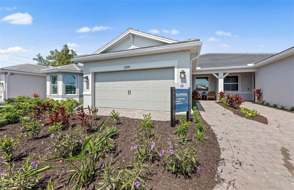 Front exterior of a new home in Legacy Groves, Nokomis, FL, highlighting curb appeal (Image 1). Front exterior of a new home in Legacy Groves, Nokomis, FL, highlighting curb appeal (Image 1).