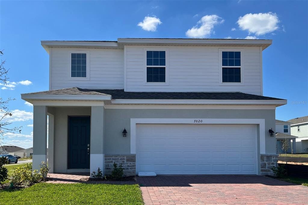 Front exterior of a new home in Trinity Lakes, Groveland, FL, highlighting curb appeal (Image 1). Front exterior of a new home in Trinity Lakes, Groveland, FL, highlighting curb appeal (Image 1).