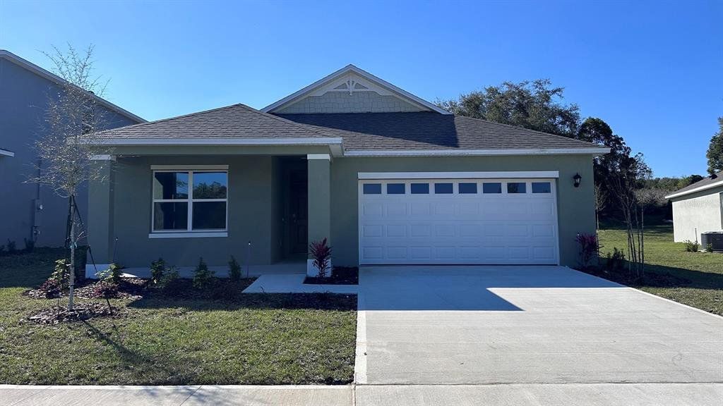 Front exterior of a new home in Summerlin at Hawthorne Ranch, Lakeland, FL, highlighting curb appeal (Image 1). Front exterior of a new home in Summerlin at Hawthorne Ranch, Lakeland, FL, highlighting curb appeal (Image 1).