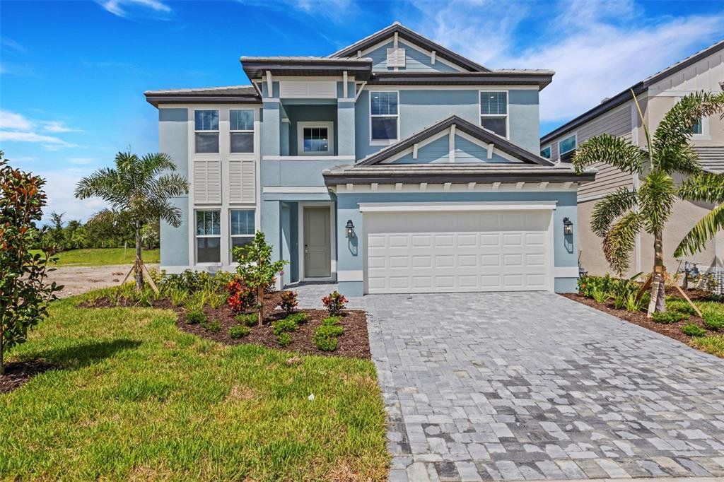 Front exterior of a new home in Hawkstone, Sarasota, FL, highlighting curb appeal (Image 1). Front exterior of a new home in Hawkstone, Sarasota, FL, highlighting curb appeal (Image 1).