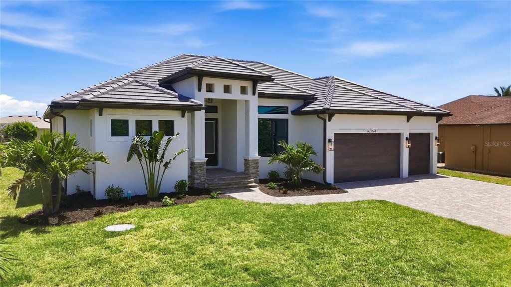 Front exterior of a new home in , Port Charlotte, FL, highlighting curb appeal (Image 1). Front exterior of a new home in , Port Charlotte, FL, highlighting curb appeal (Image 1).