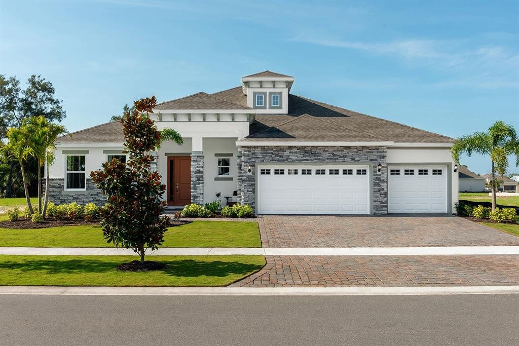 Front exterior of a new home in Marisol Pointe at MiraBay Signature Series, Apollo Beach, FL, highlighting curb appeal (Image 1). Front exterior of a new home in Marisol Pointe at MiraBay Signature Series, Apollo Beach, FL, highlighting curb appeal (Image 1).
