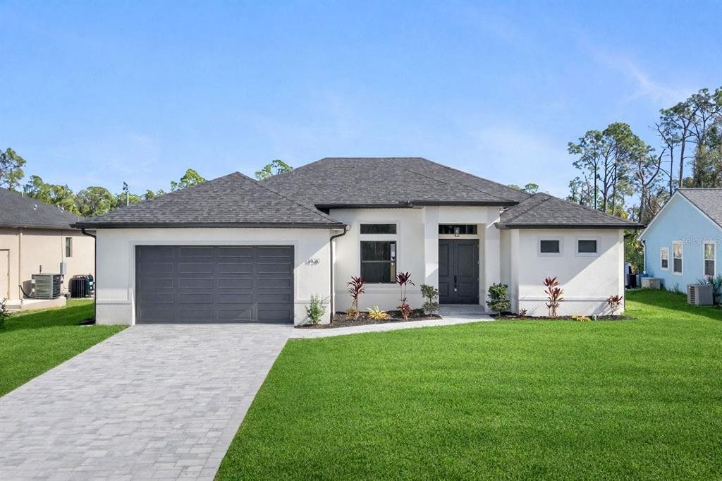 Front exterior of a new home in , North Port, FL, highlighting curb appeal (Image 1). Front exterior of a new home in , North Port, FL, highlighting curb appeal (Image 1).