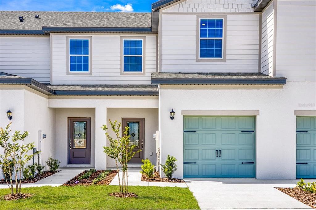 Front exterior of a new home in Sol Vista, Dundee, FL, highlighting curb appeal (Image 1). Front exterior of a new home in Sol Vista, Dundee, FL, highlighting curb appeal (Image 1).