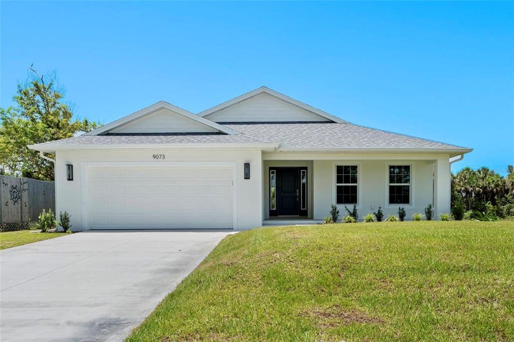 Front exterior of a new home in , Englewood, FL, highlighting curb appeal (Image 1). Front exterior of a new home in , Englewood, FL, highlighting curb appeal (Image 1).