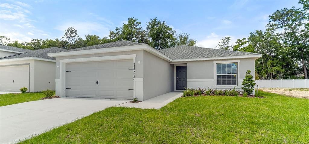 Front exterior of a new home in Vista Trace, Belleview, FL, highlighting curb appeal (Image 1). Front exterior of a new home in Vista Trace, Belleview, FL, highlighting curb appeal (Image 1).