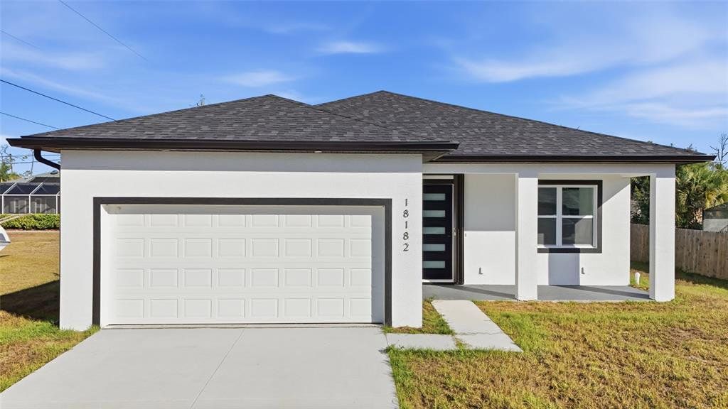 Front exterior of a new home in , Port Charlotte, FL, highlighting curb appeal (Image 1). Front exterior of a new home in , Port Charlotte, FL, highlighting curb appeal (Image 1).