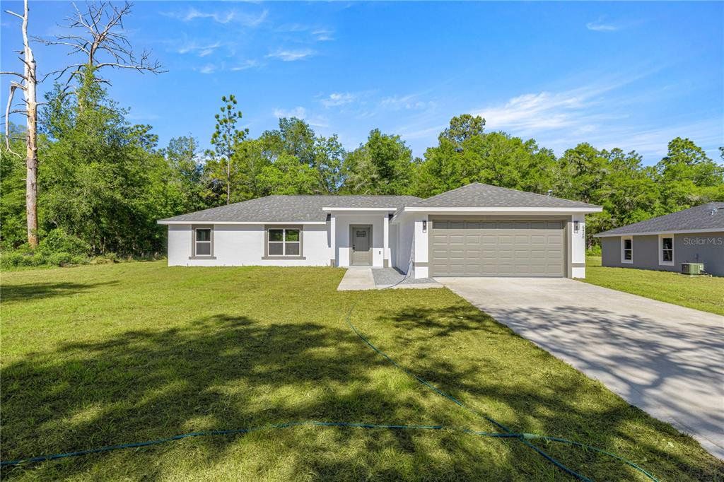 Front exterior of a new home in , Dunnellon, FL, highlighting curb appeal (Image 1). Front exterior of a new home in , Dunnellon, FL, highlighting curb appeal (Image 1).