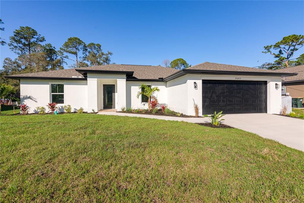 Front exterior of a new home in , North Port, FL, highlighting curb appeal (Image 1). Front exterior of a new home in , North Port, FL, highlighting curb appeal (Image 1).