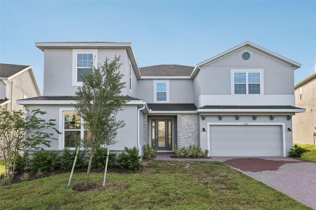 Front exterior of a new home in , Groveland, FL, highlighting curb appeal (Image 1). Front exterior of a new home in , Groveland, FL, highlighting curb appeal (Image 1).