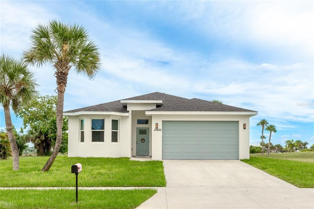 Front exterior of a new home in , Port Charlotte, FL, highlighting curb appeal (Image 1).