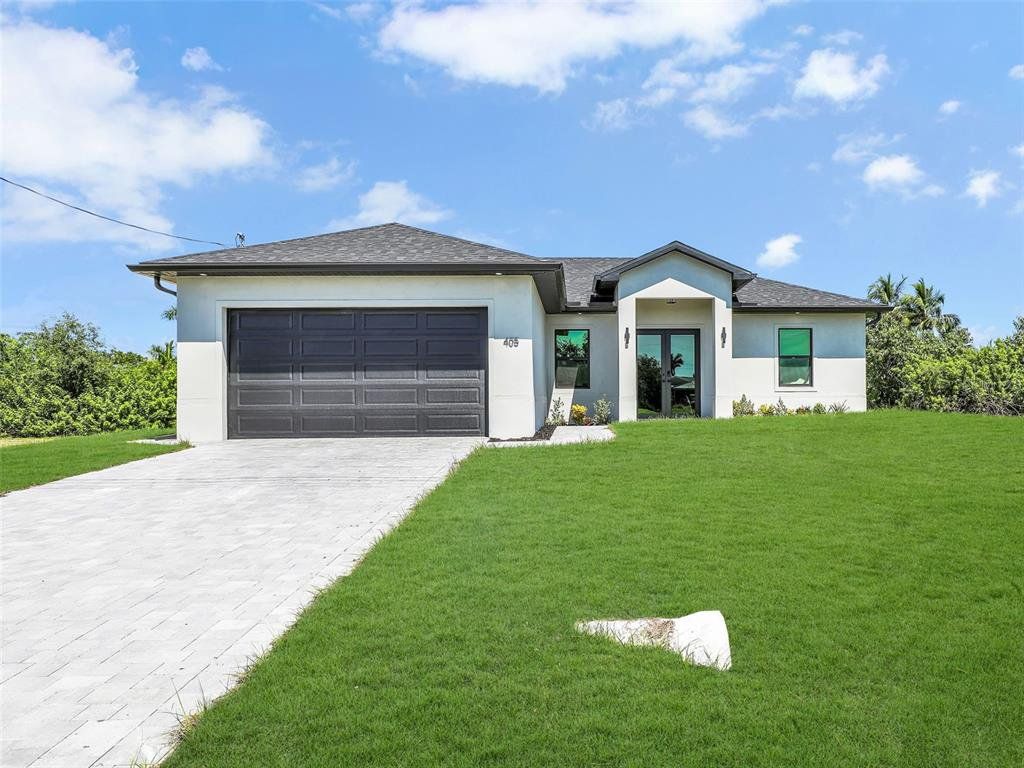 Front exterior of a new home in , Cape Coral, FL, highlighting curb appeal (Image 1). Front exterior of a new home in , Cape Coral, FL, highlighting curb appeal (Image 1).