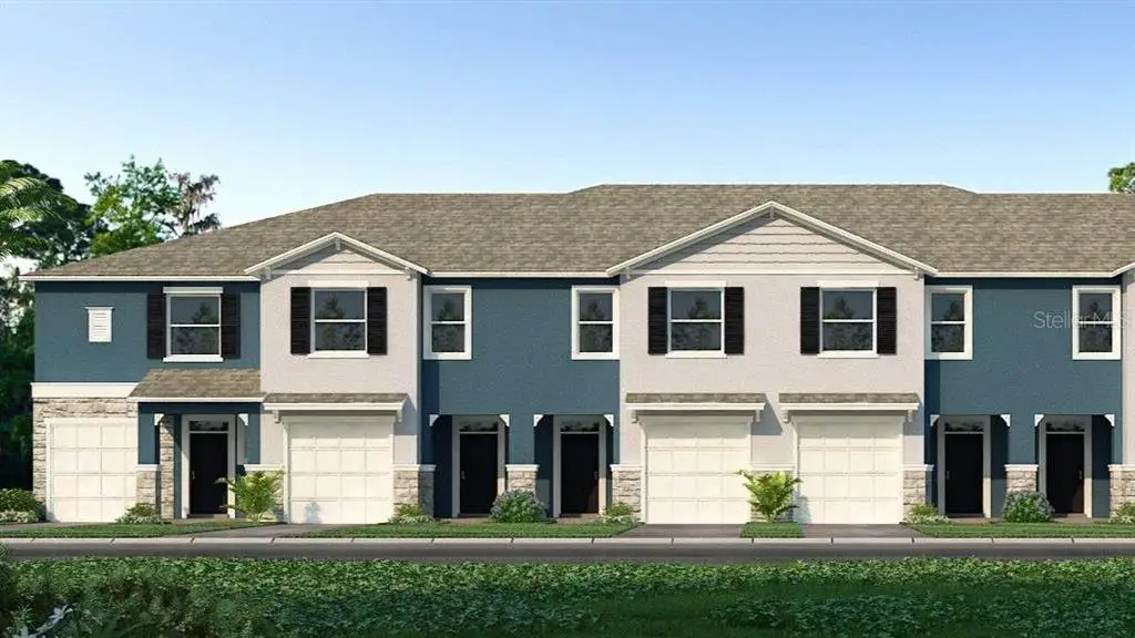 Front exterior of a new home in Bayside Pointe, Clearwater, FL, highlighting curb appeal (Image 1).
