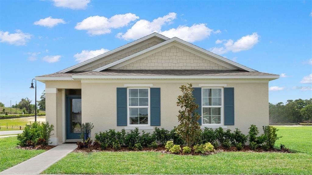 Front exterior of a new home in Crossroads at Kelly Park, Apopka, FL, highlighting curb appeal (Image 1). Front exterior of a new home in Crossroads at Kelly Park, Apopka, FL, highlighting curb appeal (Image 1).