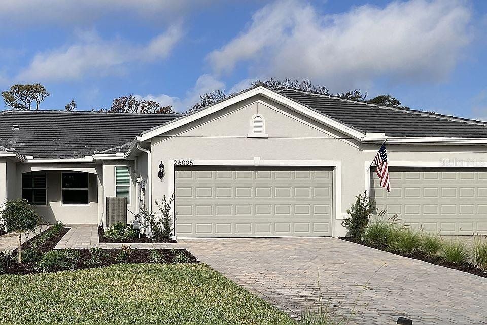Front exterior of a new home in , Englewood, FL, highlighting curb appeal (Image 1).